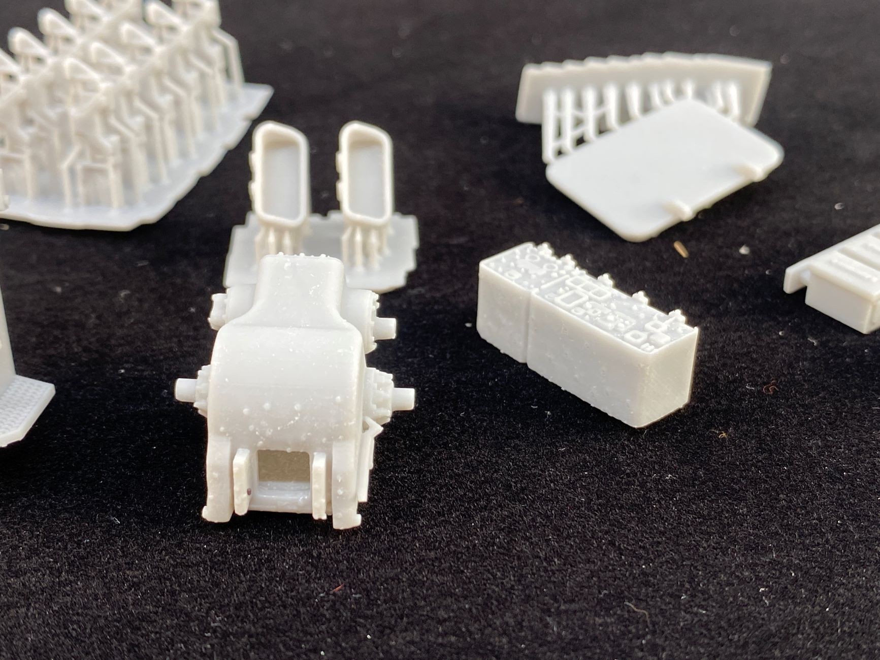 These sorts of "pimples" on 3D-printed parts are not unusual but sand off easily.
